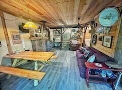 game room featuring wood ceiling and wood finished floors