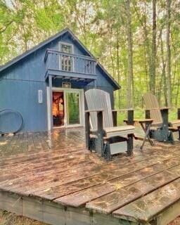 exterior space featuring a wooden deck and an outdoor structure