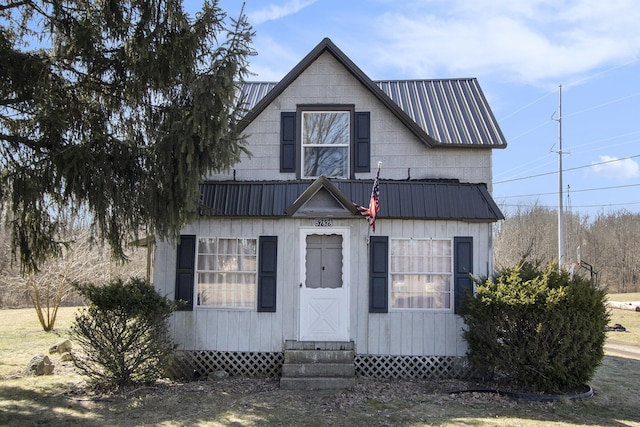 view of front of home with metal roof and entry steps