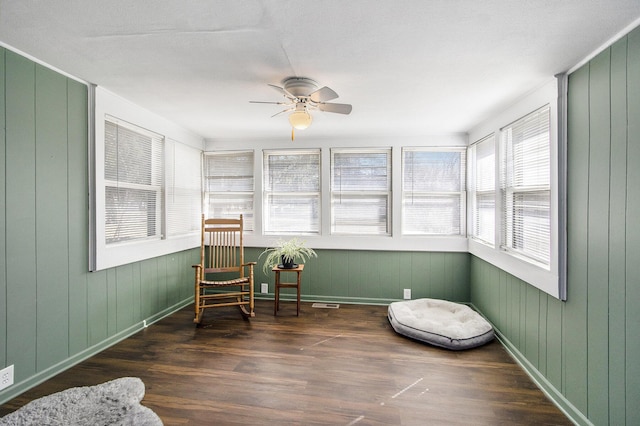 sunroom featuring visible vents and ceiling fan