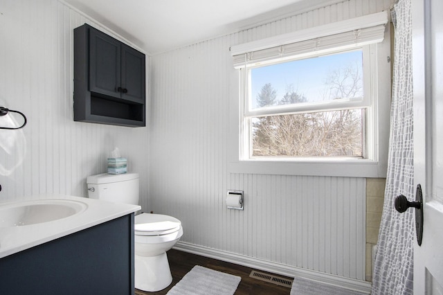 bathroom featuring vanity, toilet, wood finished floors, and visible vents