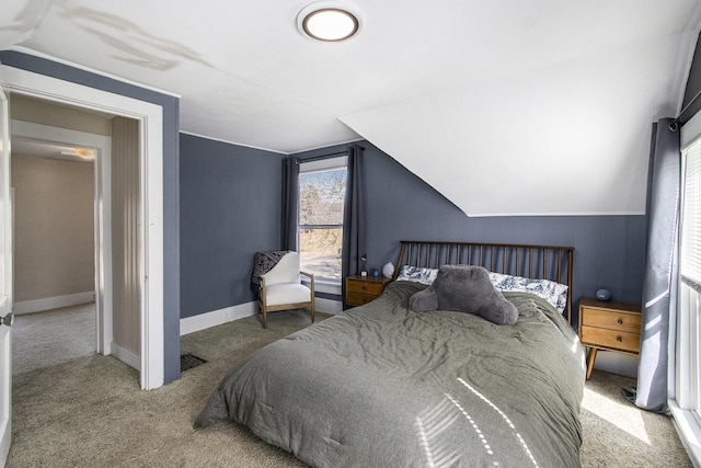 bedroom featuring visible vents, baseboards, lofted ceiling, and carpet