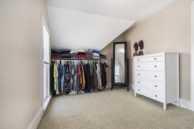 walk in closet featuring vaulted ceiling and carpet floors