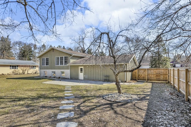 rear view of property with fence, a patio area, board and batten siding, a lawn, and brick siding