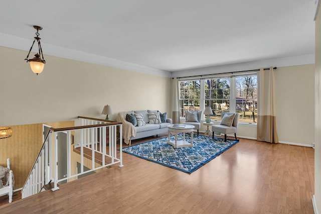 living area featuring baseboards and wood finished floors