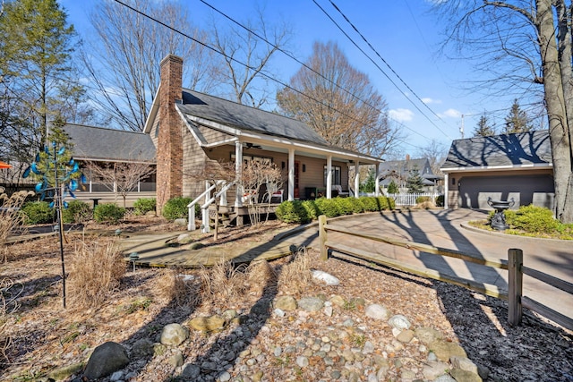 back of property featuring a porch and a chimney