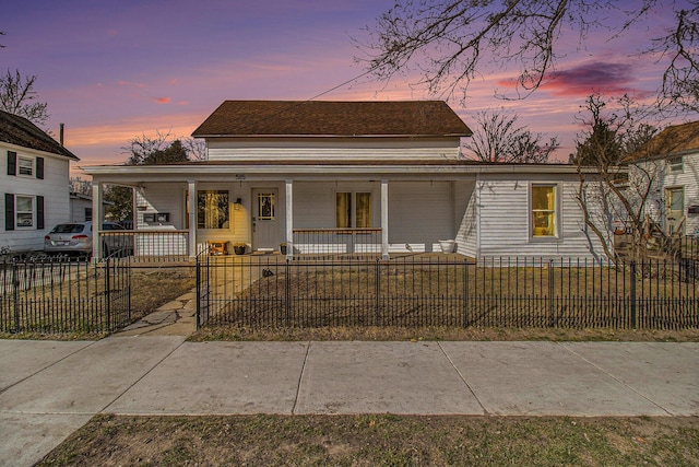 view of front of home with covered porch and a fenced front yard