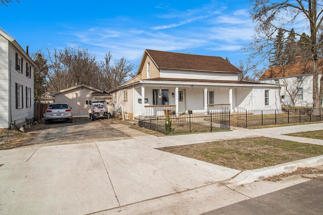 view of front of property with a fenced front yard, a porch, a shingled roof, and driveway