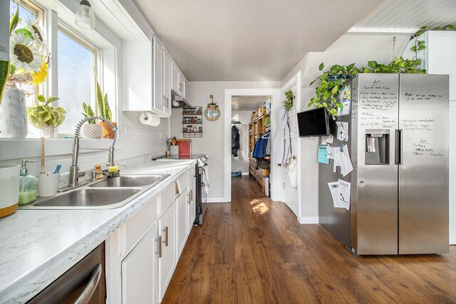 kitchen with dark wood-style floors, white cabinets, appliances with stainless steel finishes, and light countertops