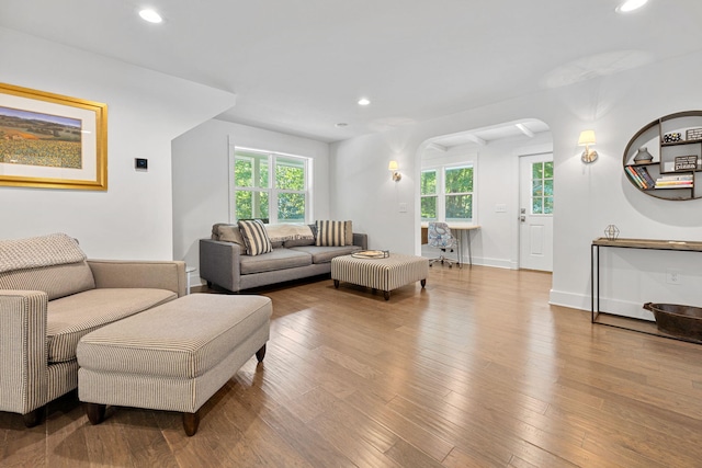living room featuring plenty of natural light, wood finished floors, and recessed lighting