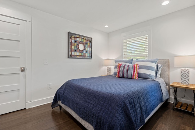 bedroom with recessed lighting, wood finished floors, and baseboards