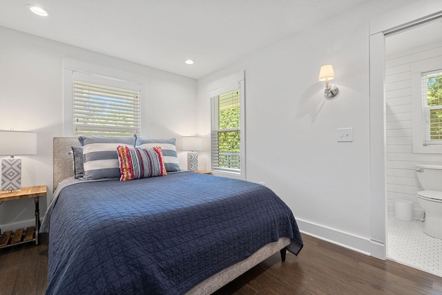 bedroom with recessed lighting, baseboards, wood finished floors, and ensuite bathroom