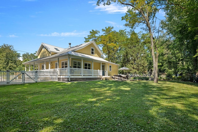 view of side of home featuring a yard, fence, metal roof, and a gate