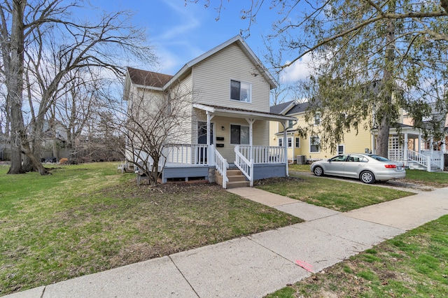 603 Gott St, Ann Arbor, MI 48103 - view of front of property with covered porch, a front lawn, and central AC unit