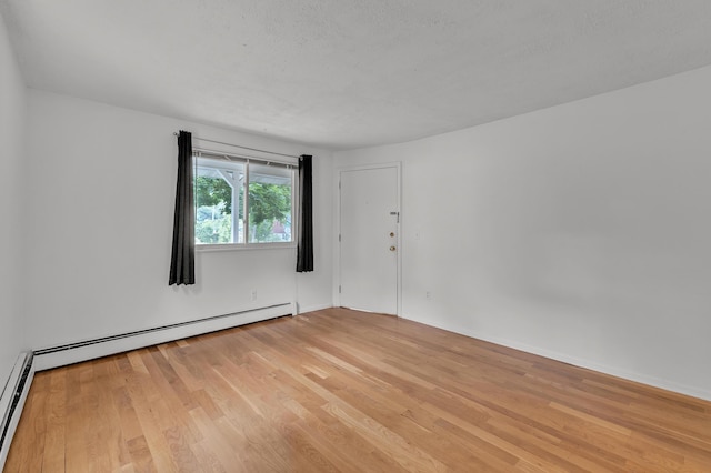 603 Gott St, Ann Arbor, MI 48103 - empty room with light wood-style floors, a baseboard radiator, and baseboards