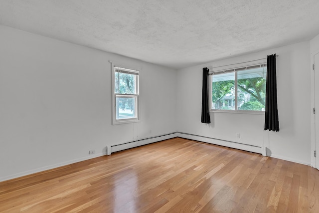 603 Gott St, Ann Arbor, MI 48103 - unfurnished room with light wood-style flooring, a textured ceiling, a baseboard radiator, and baseboards