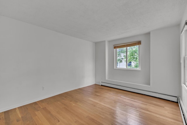 603 Gott St, Ann Arbor, MI 48103 - unfurnished room with wood finished floors, a textured ceiling, a baseboard radiator, and baseboards