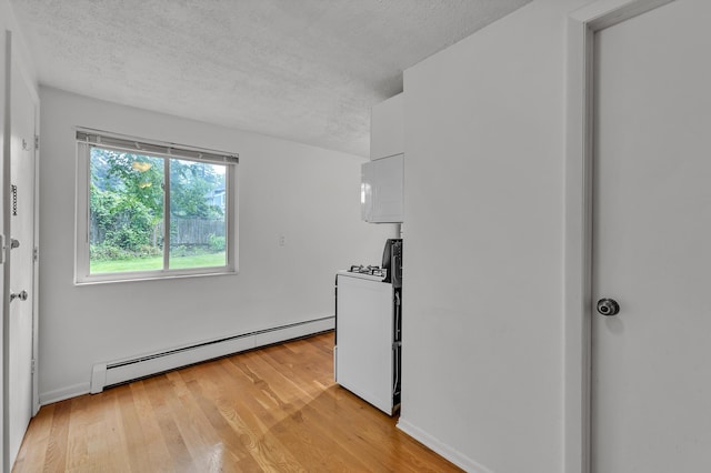 603 Gott St, Ann Arbor, MI 48103 - unfurnished room featuring baseboard heating, a textured ceiling, light wood finished floors, and baseboards