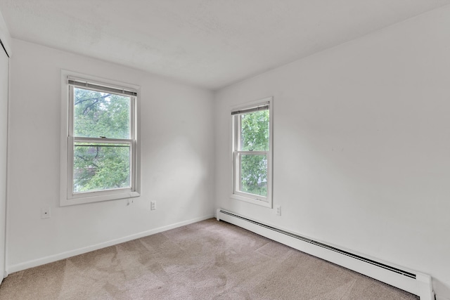 603 Gott St, Ann Arbor, MI 48103 - spare room featuring a baseboard radiator, healthy amount of natural light, carpet flooring, and baseboards