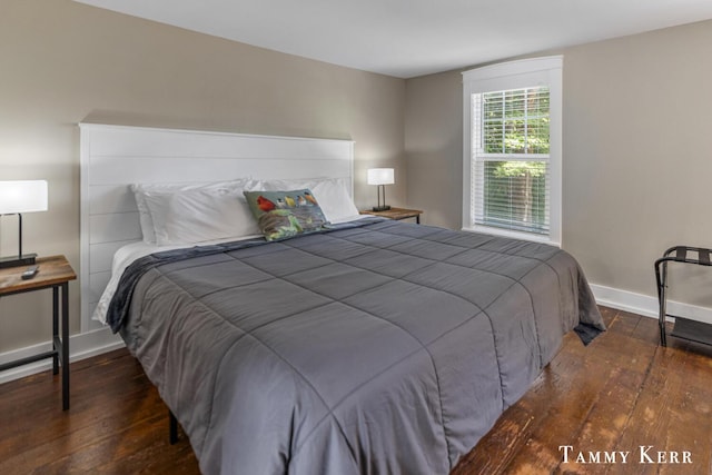 bedroom featuring baseboards and hardwood / wood-style flooring