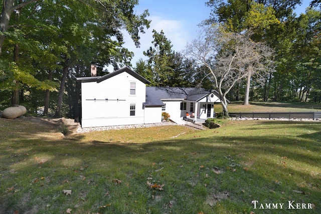 exterior space with a lawn and a chimney