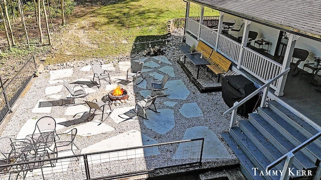 view of patio featuring stairway and a fire pit