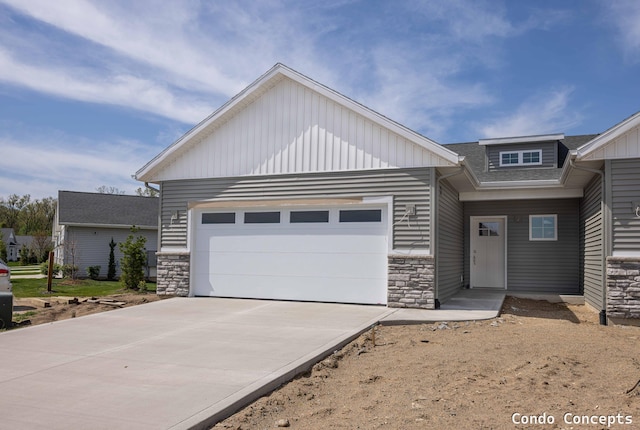 6627 Shoreside Ct SE, Grand Rapids, MI 49548 - view of front of house with stone siding, driveway, and a garage
