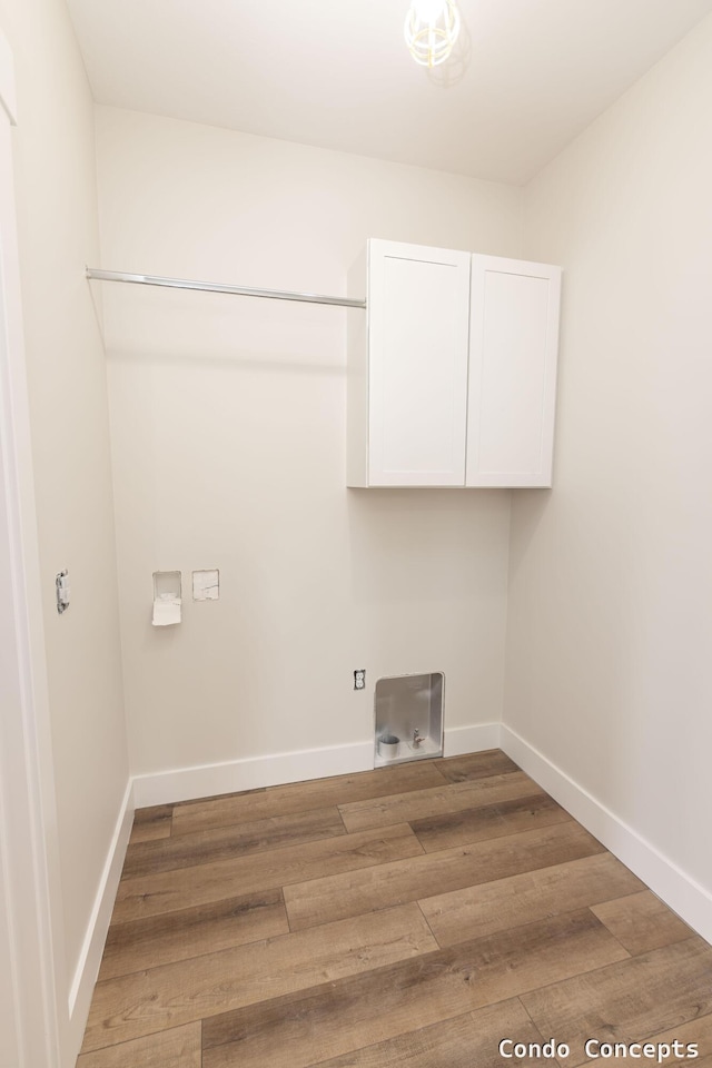 6627 Shoreside Ct SE, Grand Rapids, MI 49548 - laundry area featuring cabinet space, light wood-style flooring, baseboards, hookup for an electric dryer, and hookup for a washing machine