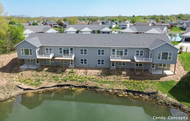 6627 Shoreside Ct SE, Grand Rapids, MI 49548 - back of house with a residential view, a deck with water view, and a shingled roof