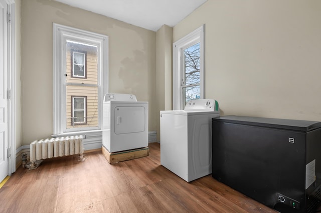 240 S Main St, Three Rivers, MI 49093 - washroom with laundry area, washer and dryer, radiator, and wood finished floors
