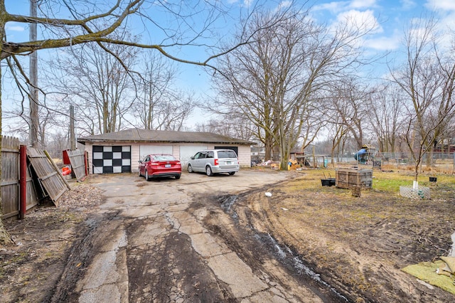 240 S Main St, Three Rivers, MI 49093 - view of front facade with an outbuilding, fence, and a detached garage