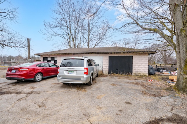 240 S Main St, Three Rivers, MI 49093 - view of side of home with a detached garage, an outdoor structure, and fence