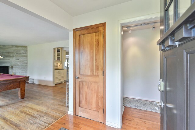 interior space featuring baseboards and light wood finished floors