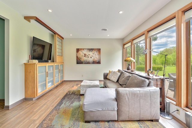 living room featuring recessed lighting, light wood-type flooring, baseboards, and visible vents