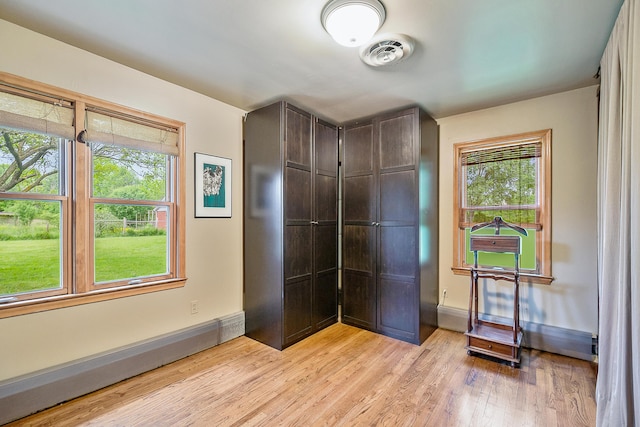 unfurnished bedroom featuring visible vents, baseboards, and light wood finished floors