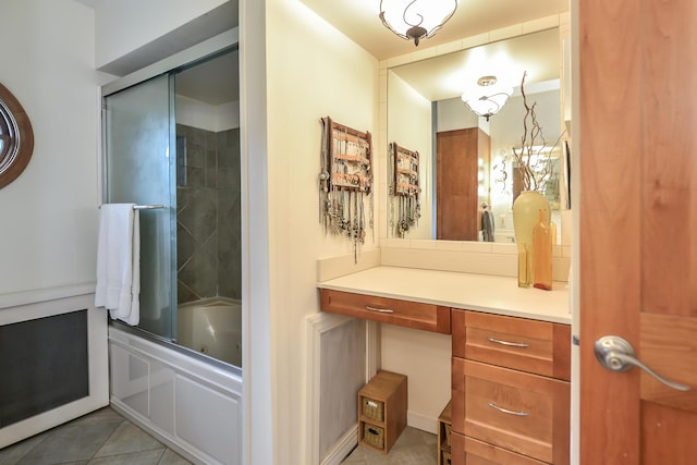 full bathroom featuring shower / bath combination with glass door, vanity, and tile patterned flooring