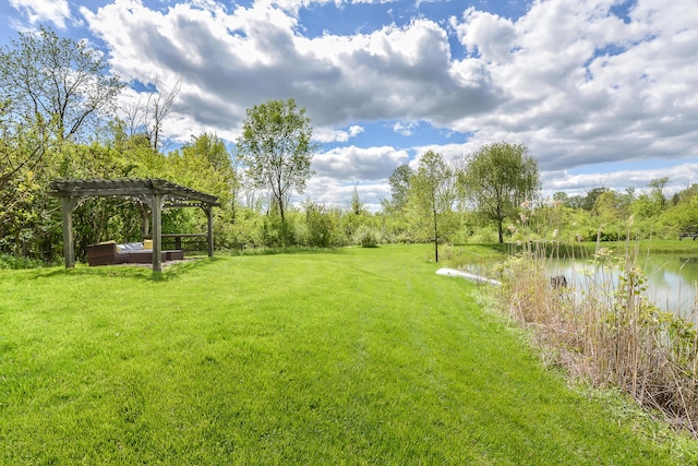 view of yard featuring a water view and a pergola