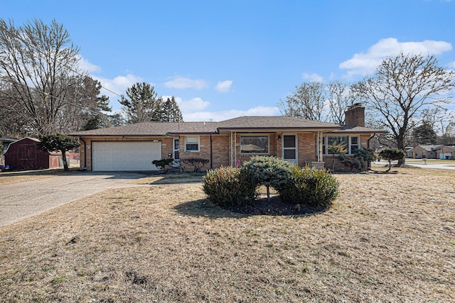 single story home with brick siding, an attached garage, concrete driveway, and a chimney