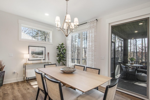 dining space featuring recessed lighting, a chandelier, baseboards, and wood finished floors