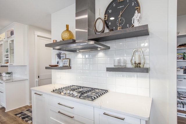 kitchen with open shelves, wood finished floors, white cabinetry, stainless steel gas stovetop, and exhaust hood