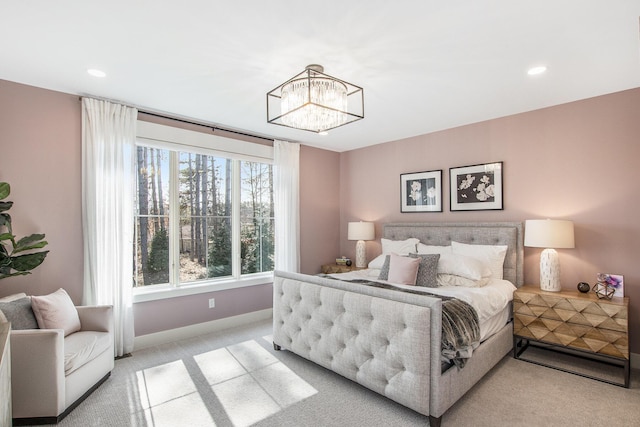 bedroom featuring an inviting chandelier, recessed lighting, light colored carpet, and baseboards