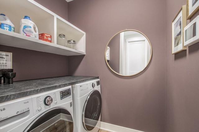 clothes washing area featuring washer and clothes dryer and laundry area