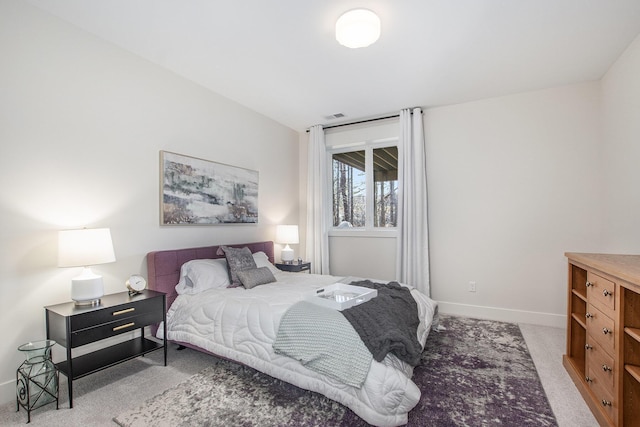 carpeted bedroom featuring visible vents and baseboards