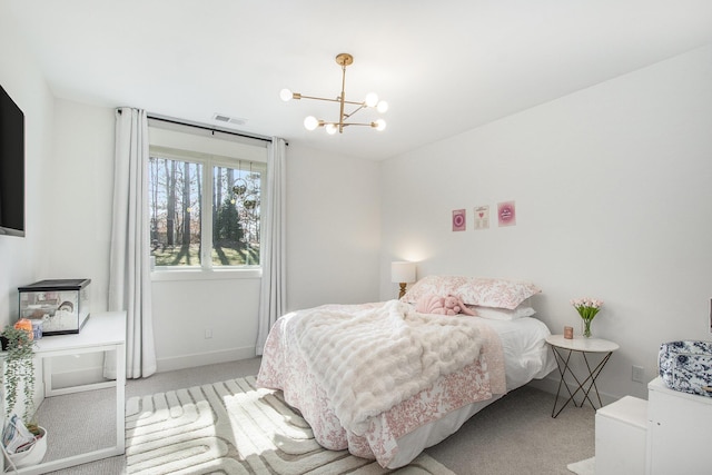 carpeted bedroom with visible vents, baseboards, and an inviting chandelier