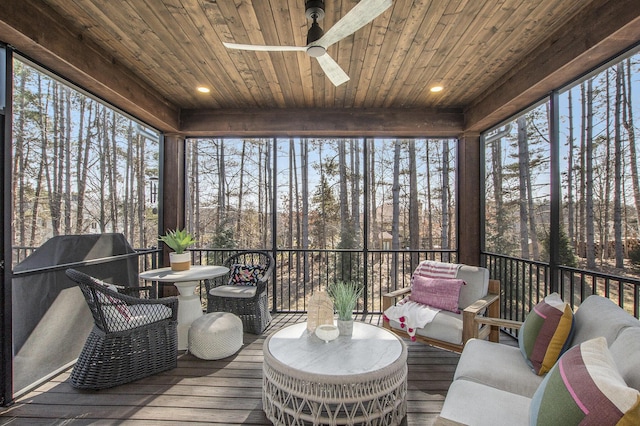 sunroom / solarium with wood ceiling and a ceiling fan