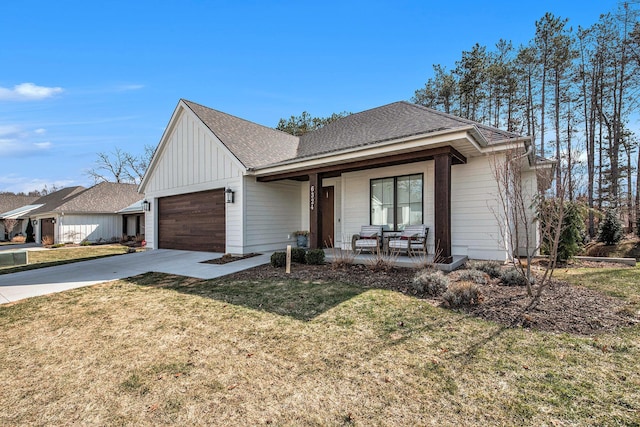 view of front facade with driveway, a front lawn, a porch, board and batten siding, and an attached garage