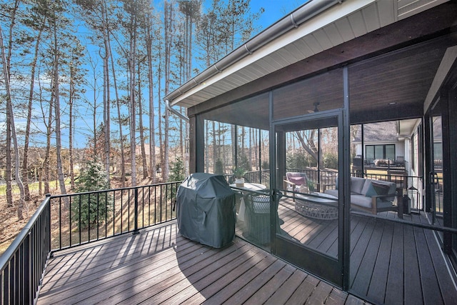 wooden deck featuring area for grilling and a sunroom