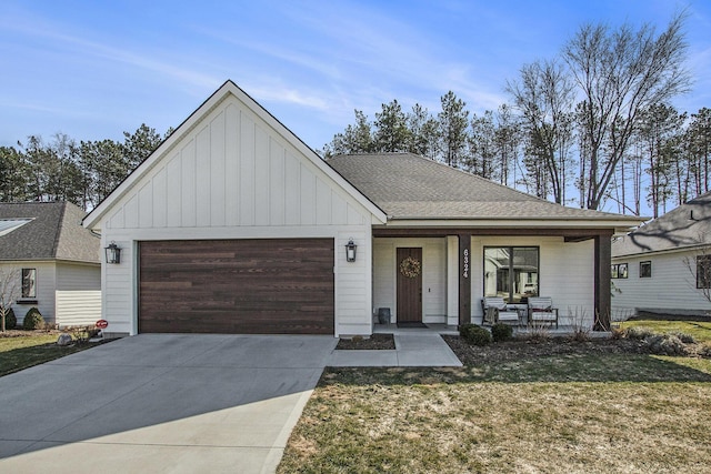 view of front of home featuring roof with shingles, a porch, concrete driveway, a garage, and board and batten siding