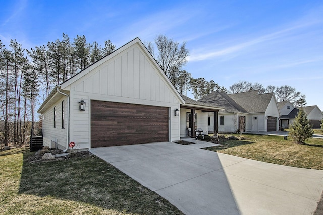 view of front facade featuring board and batten siding, concrete driveway, a garage, and a front yard