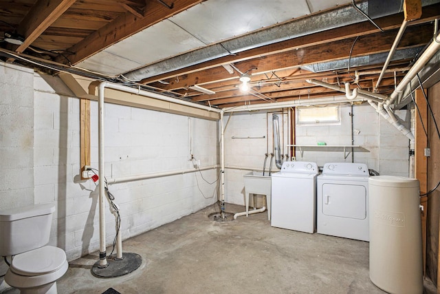 basement featuring washing machine and dryer and a sink